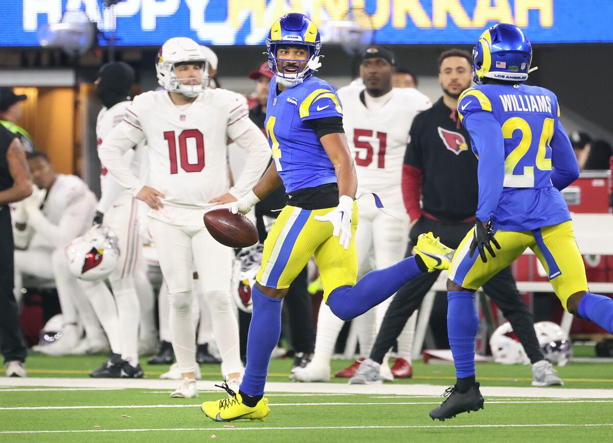 The Rams' Ahkello Witherspoon (4) runs up the sideline in celebration after his  interception against the Cardinals.