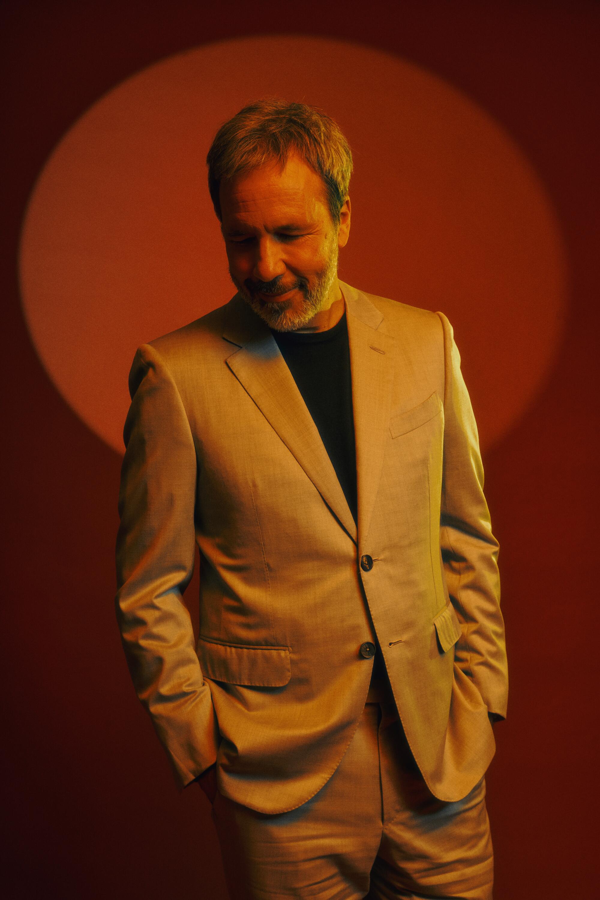 A portrait of Denis Villeneuve looking down.