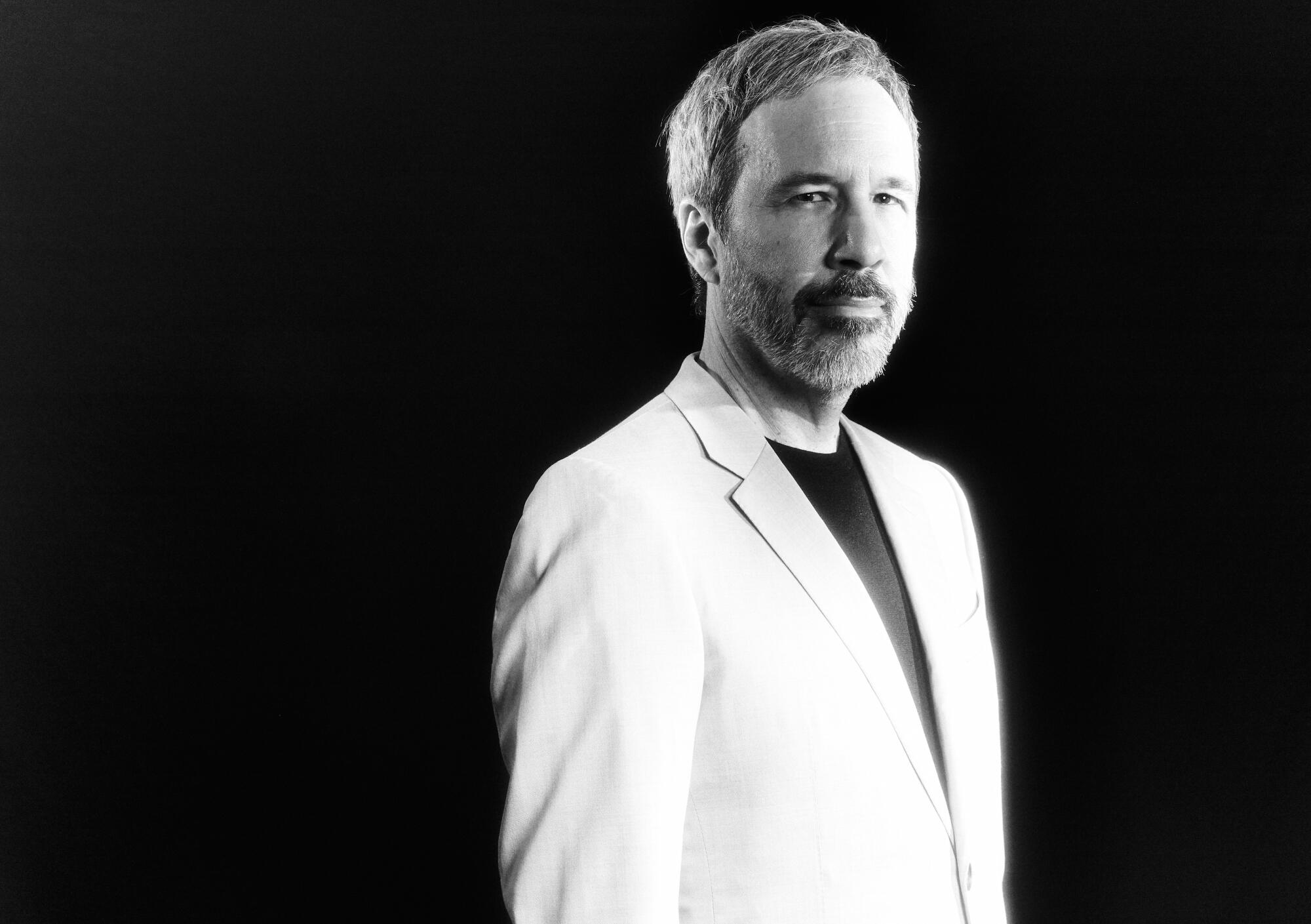 A black-and-white portrait of Denis Villeneuve.