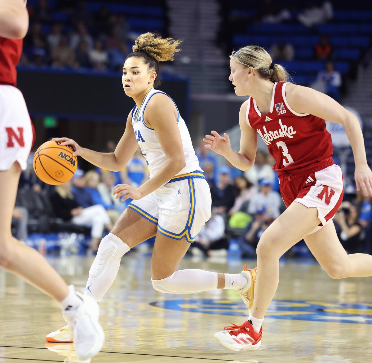 UCLA's Kiki Rice, left, dribbles past Nebraska's Allison Weidner during the Bruins' win Sunday.