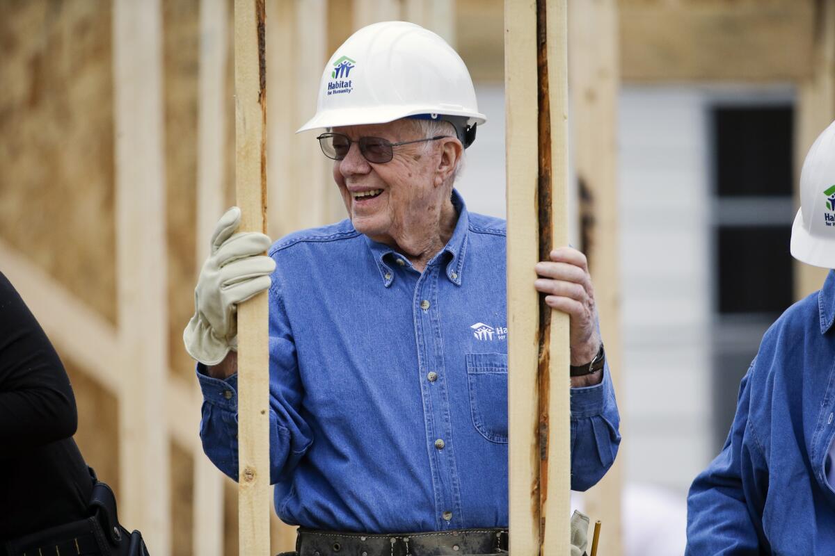 President Carter wearing a hard hat at a building site