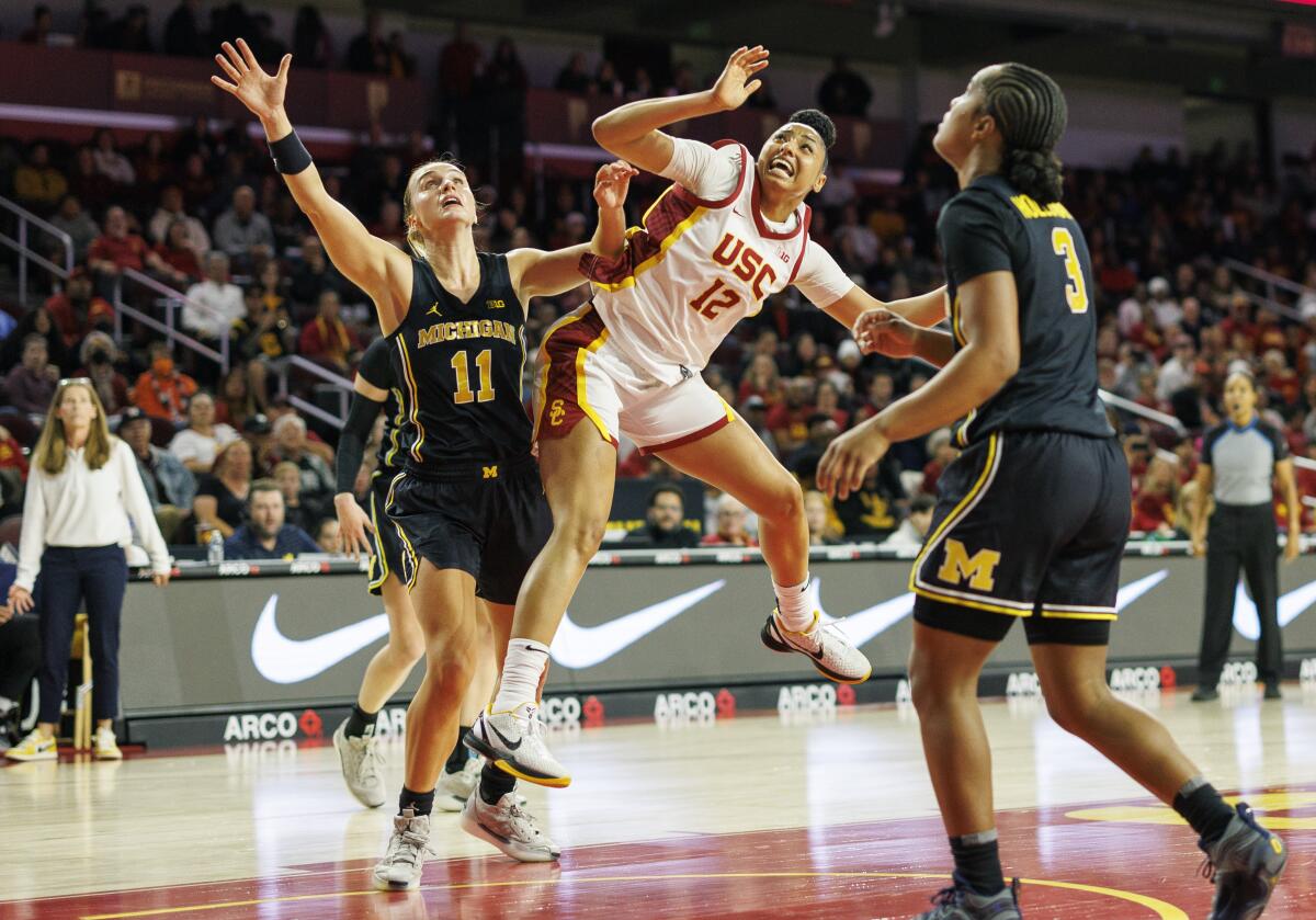 USC guard JuJu Watkins collides with Michigan Wolverines guard Greta Kampschroeder.