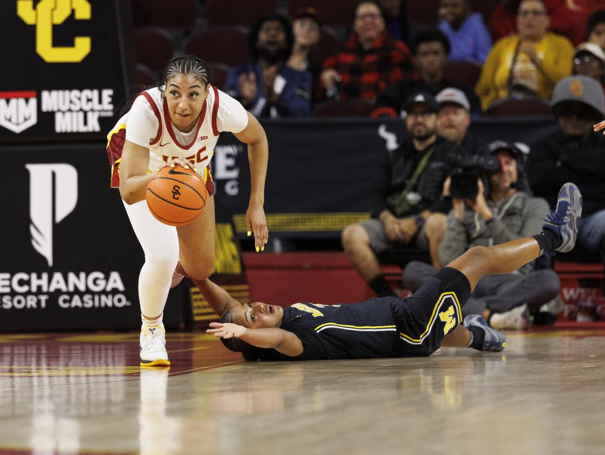 USC guard Kennedy Smith steals the ball from Michigan guard Mila Holloway during the first half Sunday.