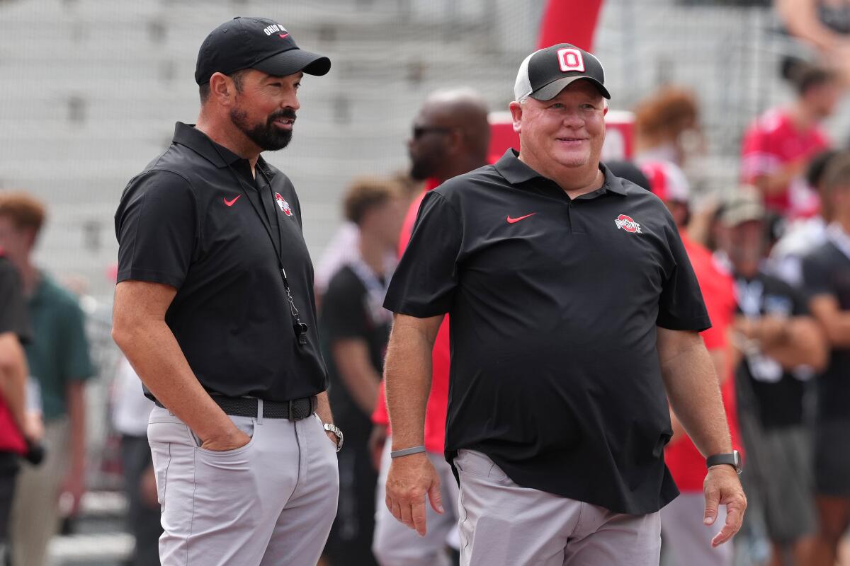 Ohio State head coach Ryan Day, left, talks with offensive coordinator Chip Kelly before a game against Akron.