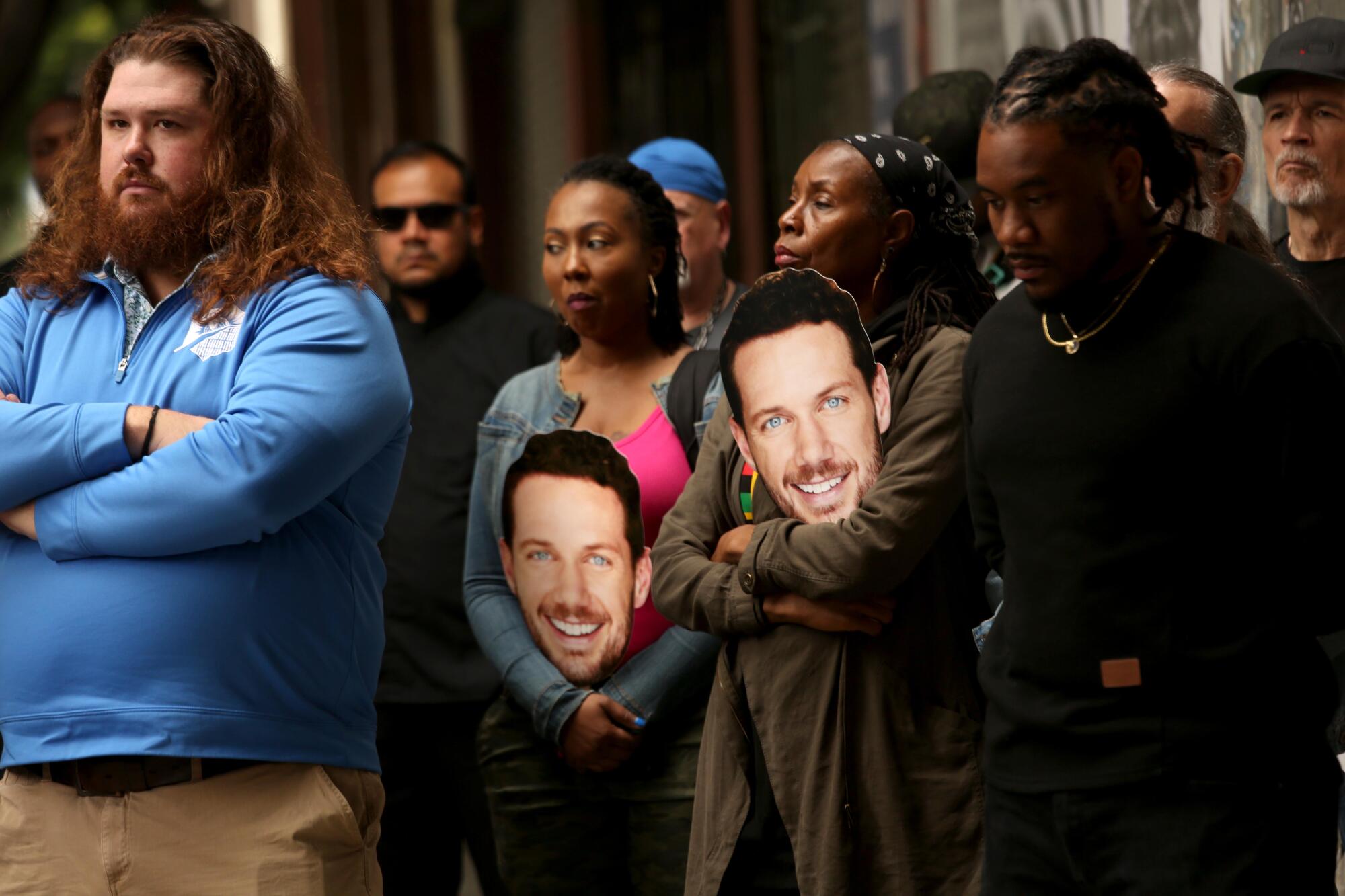 Grant Wactor, left, the brother of actor Johnny Wactor, joins a rally to protest the shooting death of actor.