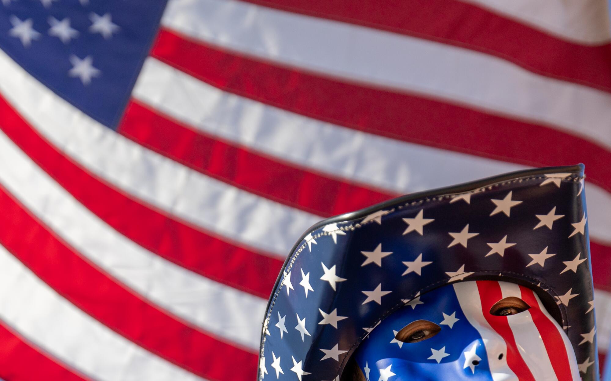 A man in a mask and hat with the American flag pattern