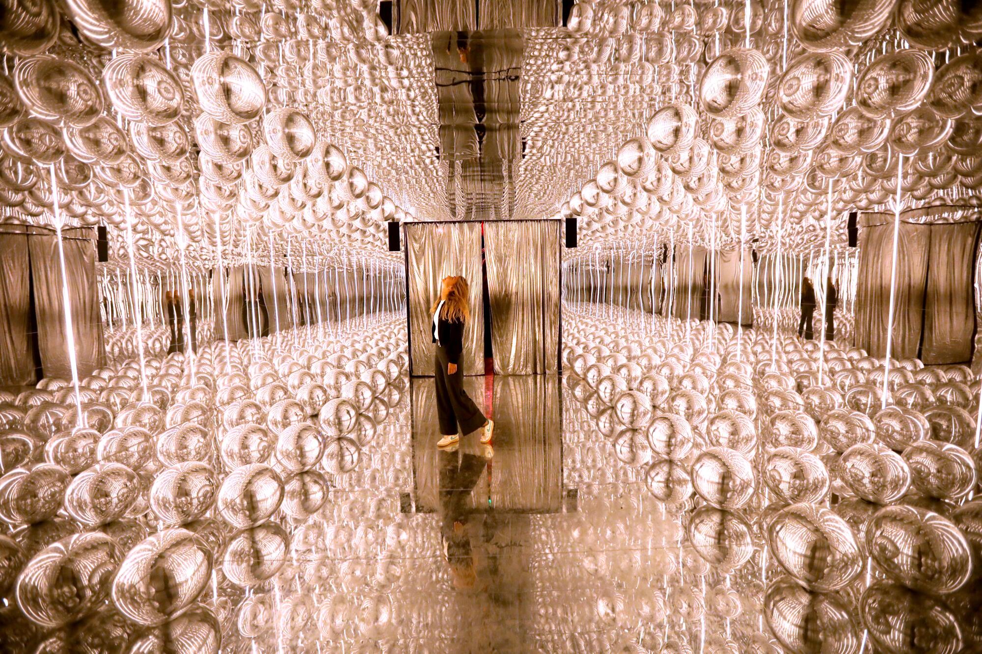 Maristella Burchietti is immersed in the exhibit titled, "BB" by artist Tadao Cern at the Balloon Museum's.