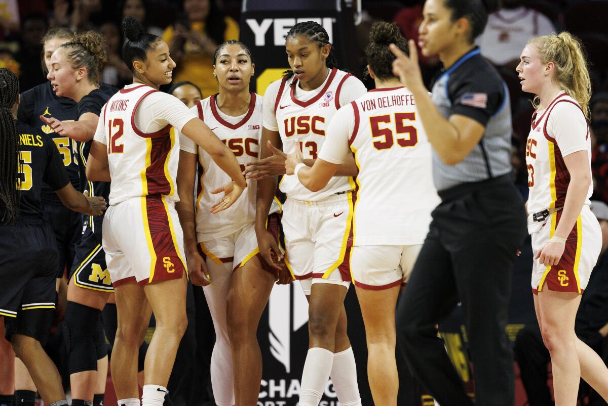 USC's Rayah Marshall is congratulated by her teammates after scoring while drawing a foul against Michigan.