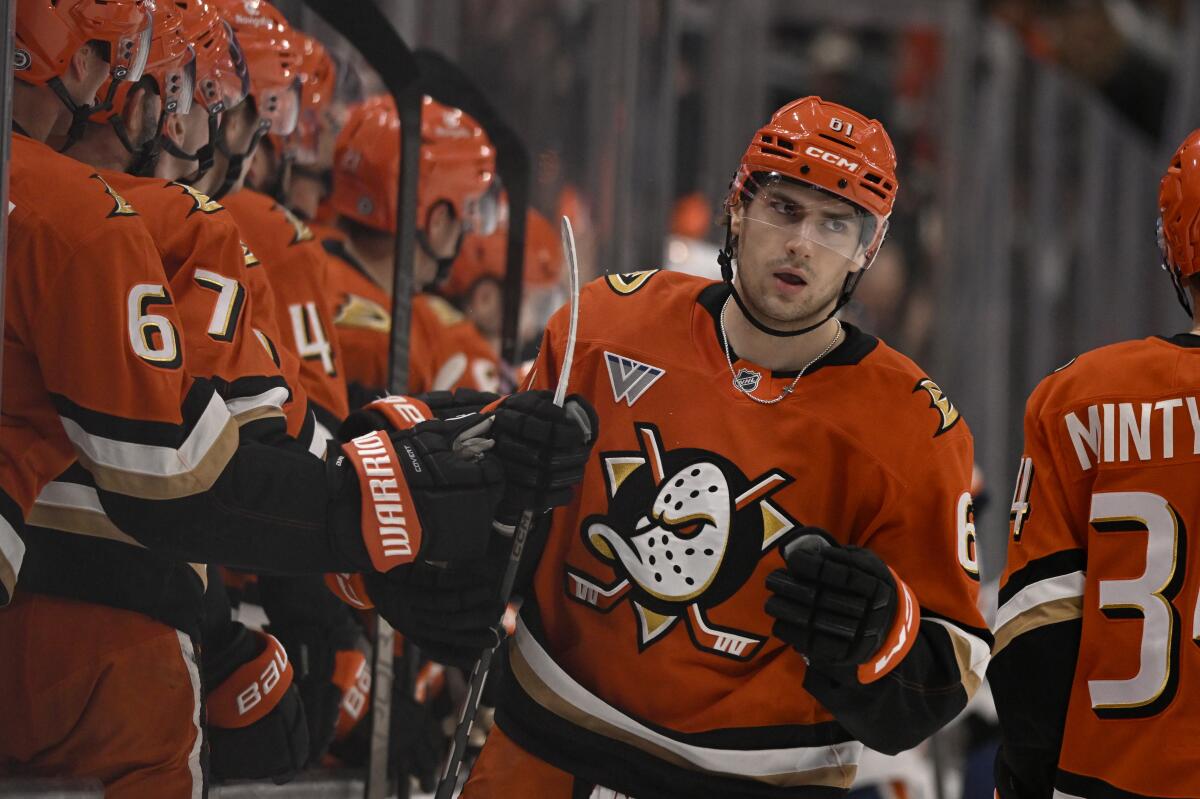 Ducks forward Cutter Gauthier celebrates with teammates after scoring.