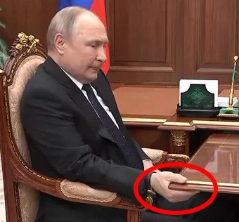 A sickly Putin appeared in pain as he was seen tightly gripping a table in 2022