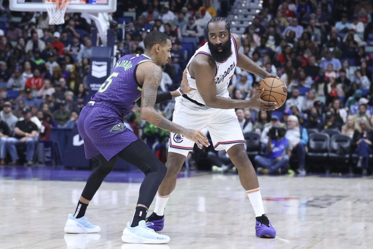 Clippers guard James Harden controls the ball in front of New Orleans Pelicans guard Dejounte Murray.