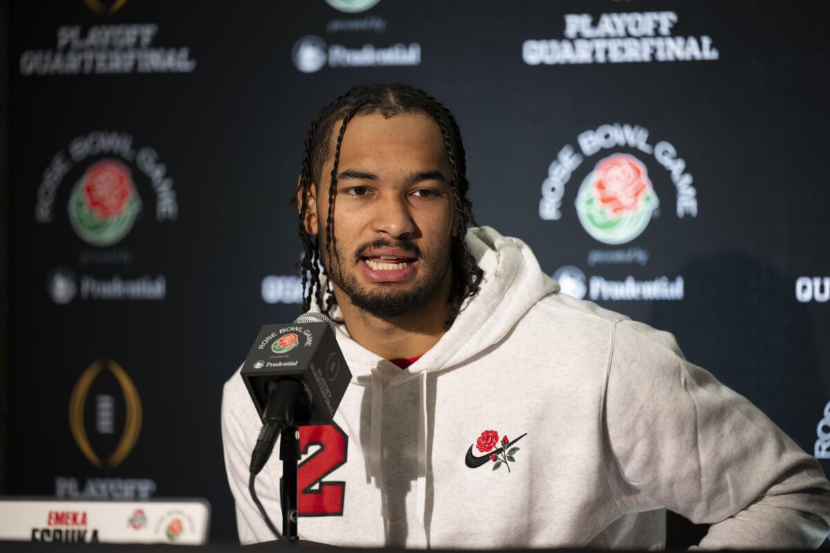 Ohio State wide receiver Emeka Egbuka speaks to reporters during a news conference.