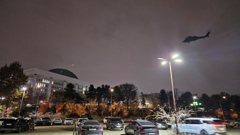 A helicopter flies around the National Assembly