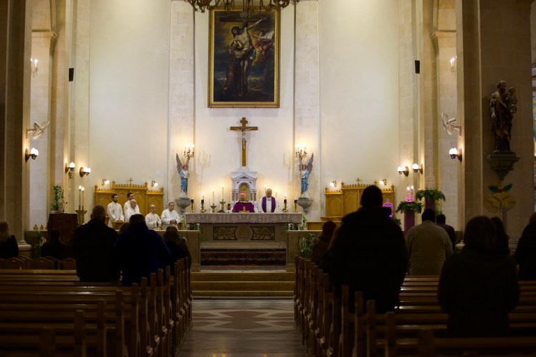 Worshippers at church in Aleppo. [Ali Haj Suleiman/Al Jazeera]