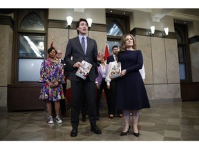 Justin Trudeau and Chrystia Freeland hold copies of the government's 2024 budget in April.