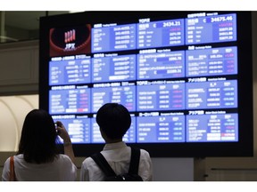 Visitors in front of an electric stock board at the Tokyo Stock Exchange (TSE) in Tokyo, Japan, on Tuesday, Aug. 6, 2024. Japanese stocks rallied after their plunge into a bear market during the previous day's trading brought them down to key technical levels. Photographer: Kiyoshi Ota/Bloomberg