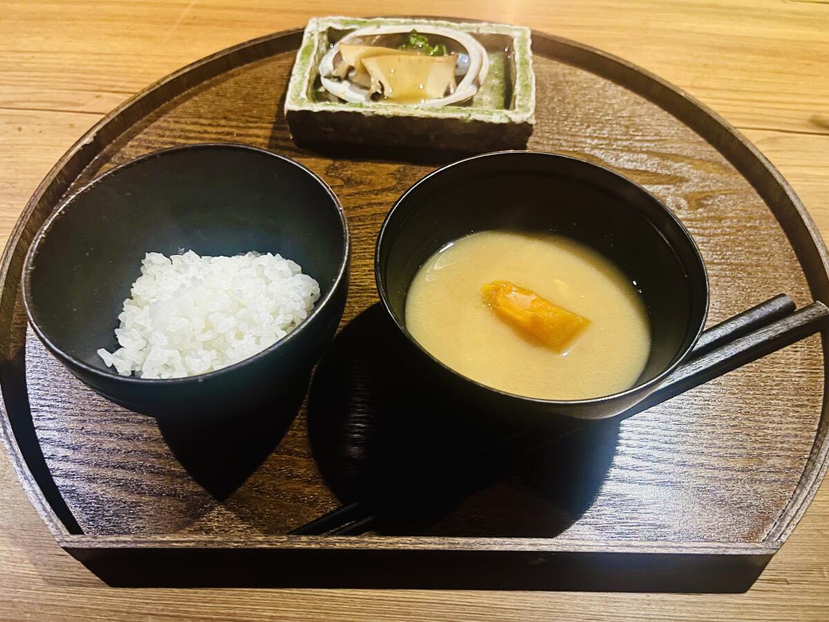 A tray of miso soup, rice and abalone