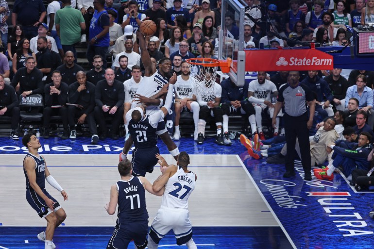 Anthony Edwards dunks during NBA game.