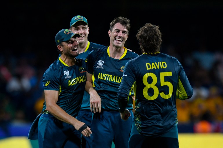 Australia's Pat Cummins (3L) and Marcus Stoinis (L) celebrates after the dismissal of Afghanistan's Gulbadin Naib during the ICC men's Twenty20 World Cup 2024 Super Eight cricket match between Afghanistan and Australia at Arnos Vale Stadium in Arnos Vale, Saint Vincent and the Grenadines on June 22, 2024. (Photo by Randy Brooks / AFP)