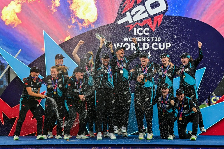 New Zealand's players celebrate with their winning trophy at the end of the ICC Women's T20 World Cup cricket final match between South Africa and New Zealand at the Dubai International Cricket Stadium in Dubai on October 20, 2024. (Photo by Giuseppe CACACE / AFP)