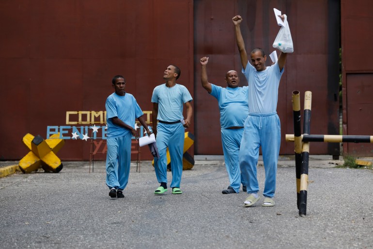 Detainees in blue jumpsuits leave a Venezuela prison