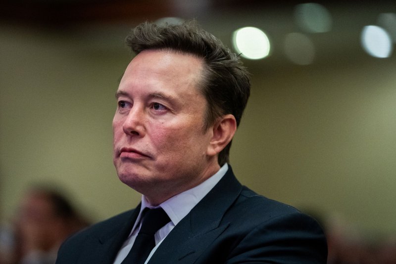 Elon Musk listens as U.S. President-elect Donald Trump speaks during a meeting with House Republicans at the Hyatt Regency Hotel in Washington, D.C., on November 13. On Monday, a judge in Delaware ruled against his company Tesla awarding him a multi-billion-dollar compensation package. Pool File Photo by Allison Robbert/UPI