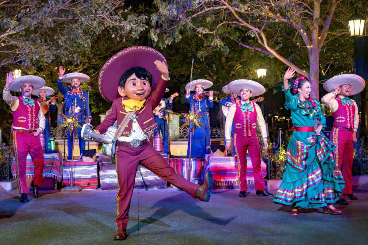 The character of Miguel from 'Coco' in a celebratory pose at Disney California Adventure