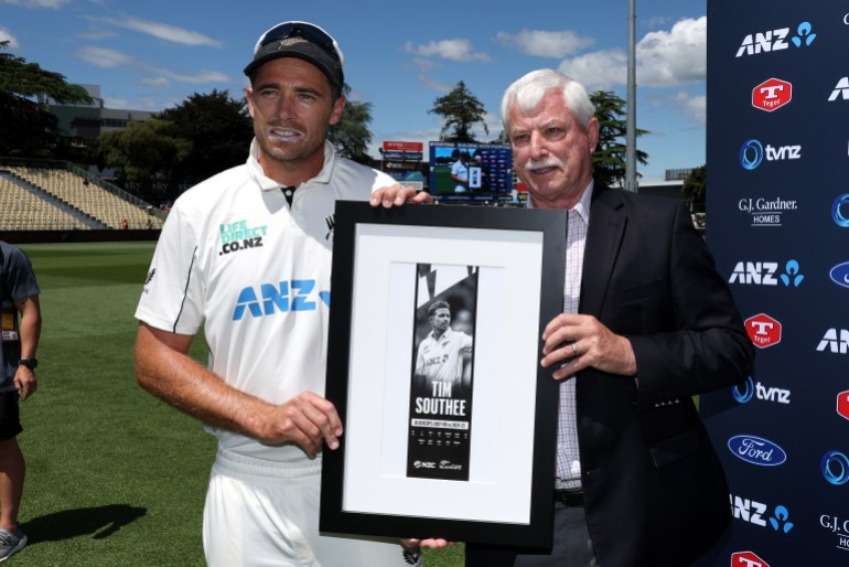 HAMILTON, NEW ZEALAND - DECEMBER 17: Tim Southee of New Zealand is presented a gift by Sir Richard Hadlee at the end of day four of the Third Test Match in the series between New Zealand and England at Seddon Park on December 17, 2024 in Hamilton, New Zealand. (Photo by Phil Walter/Getty Images)