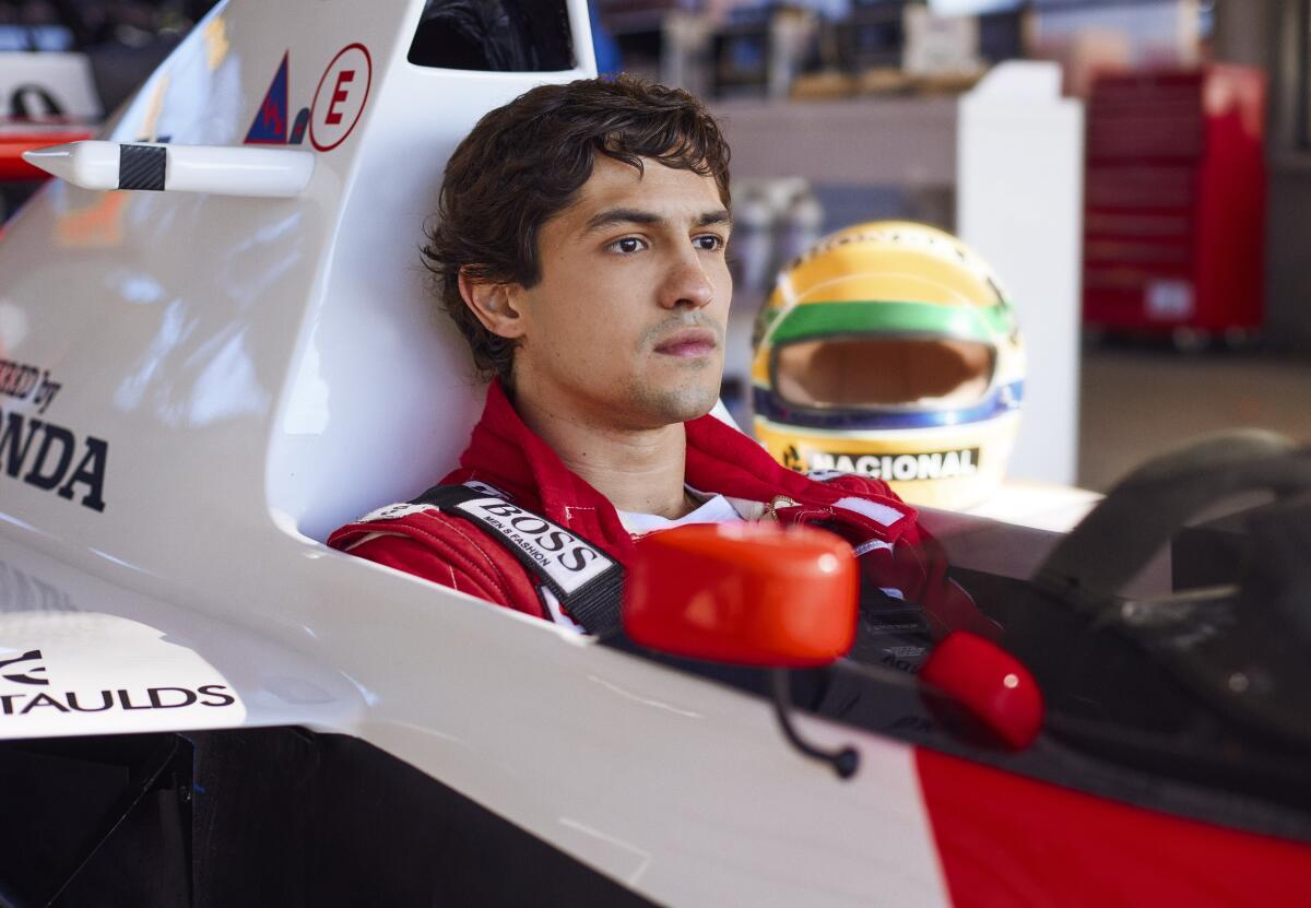 A man sits in the cockpit of an F1 race car.