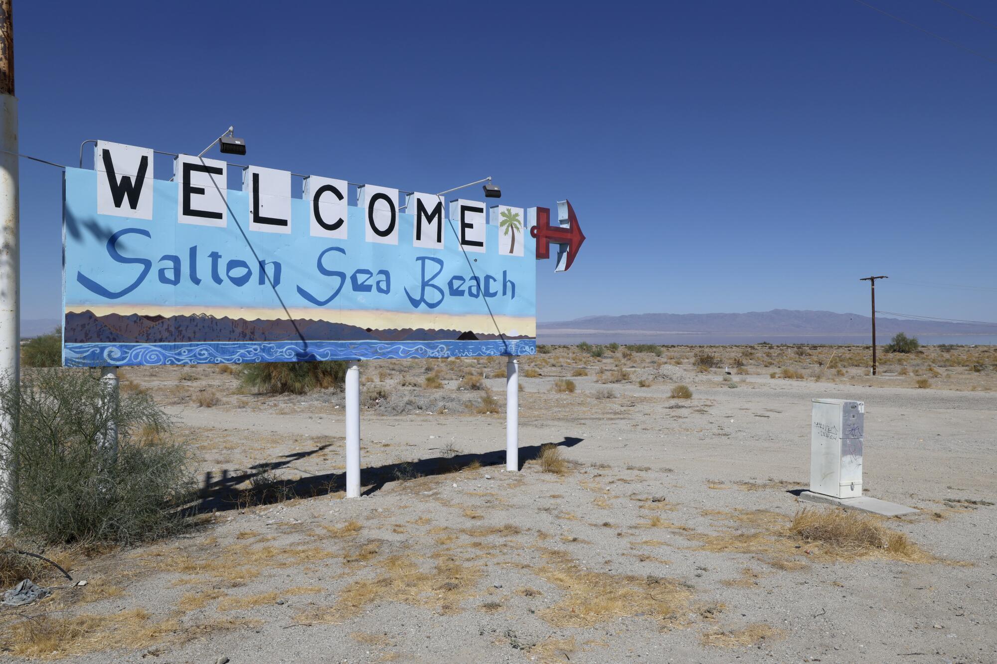 A welcome sign stands at the entrance to Desert Shores next to the shrinking Salton Sea in the Imperial Valley. 