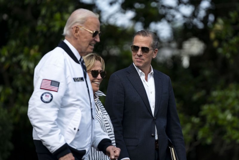 Hunter Biden looks toward President Joe Biden and Valerie Biden Owens while exiting the White House to board Marine One en route to Camp David in July. On Sunday, Biden pardoned his son on weapons and tax evasion convictions. File Photo by Bonnie Cash/UPI