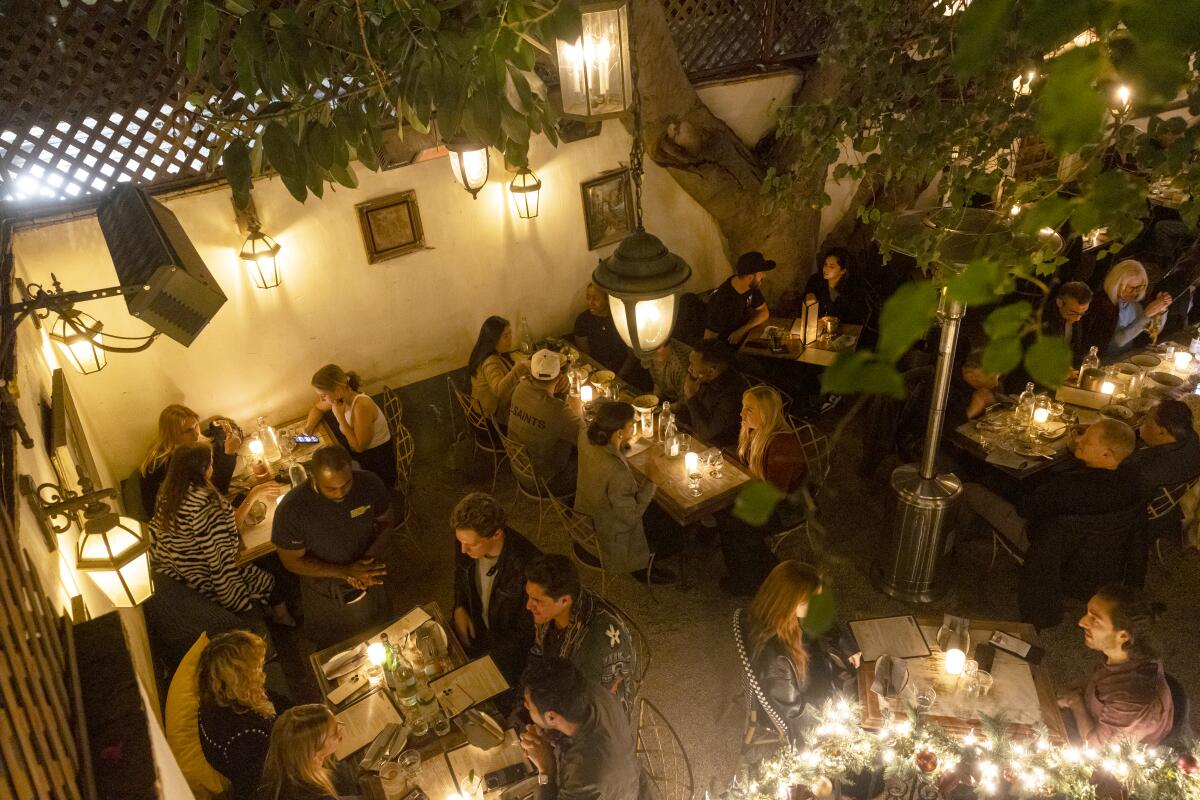 Strangers interact as they dine together at Bacari in Los Angeles 