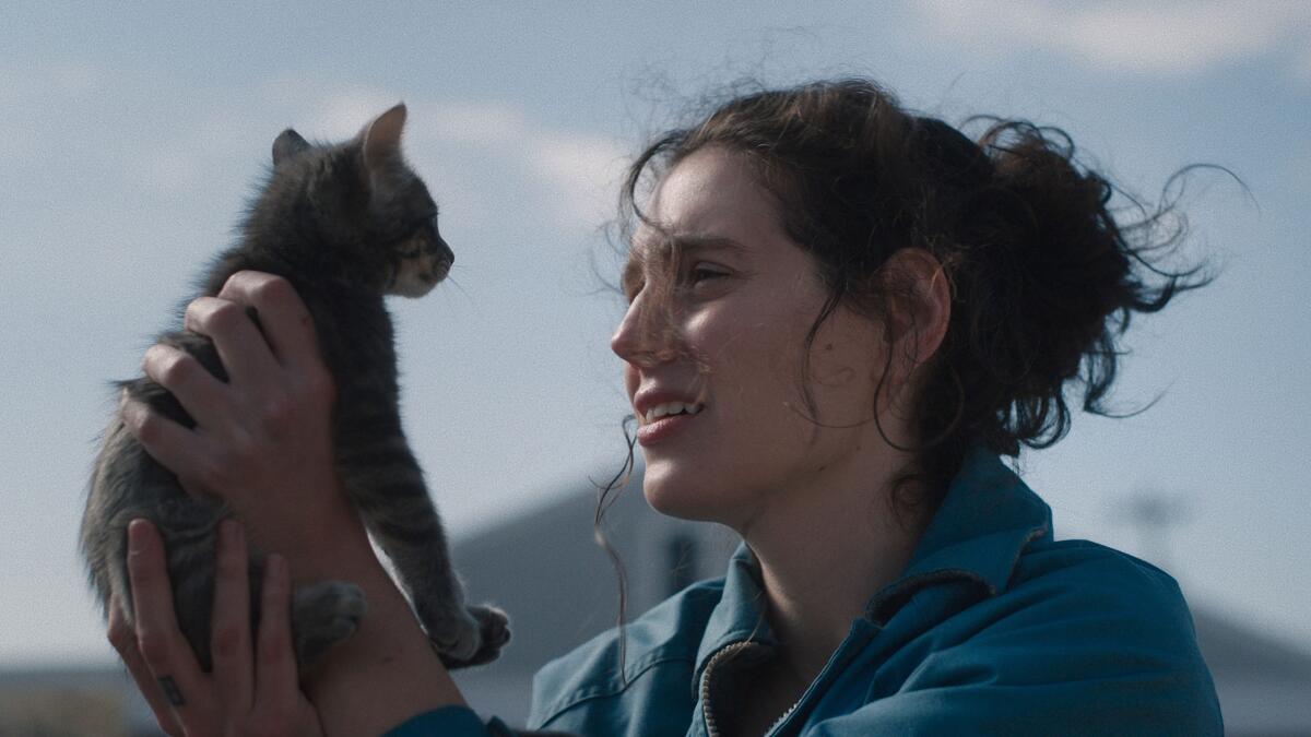 Eva Victor holding up a kitten