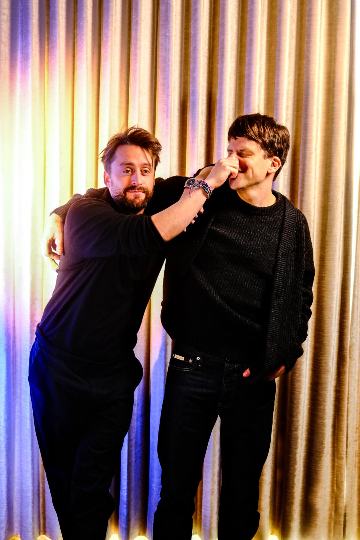 Kieran Culkin tweaks Jesse Eisenberg's nose as they stand side by side