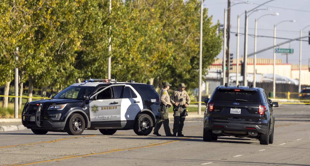 Los Angeles County Sheriff's deputies secure the scene Sunday morning in Palmdale.