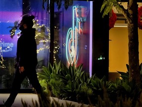 A neon TikTok logo hangs in the lobby of the TikTok office building in Culver City, Calif., on Tuesday, Dec. 3, 2024.