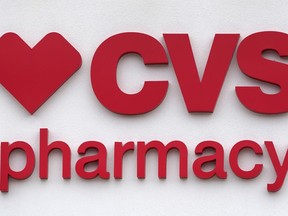 FILE - The CVS Pharmacy logo is displayed on a store on Aug. 3, 2021, in Woburn, Mass.