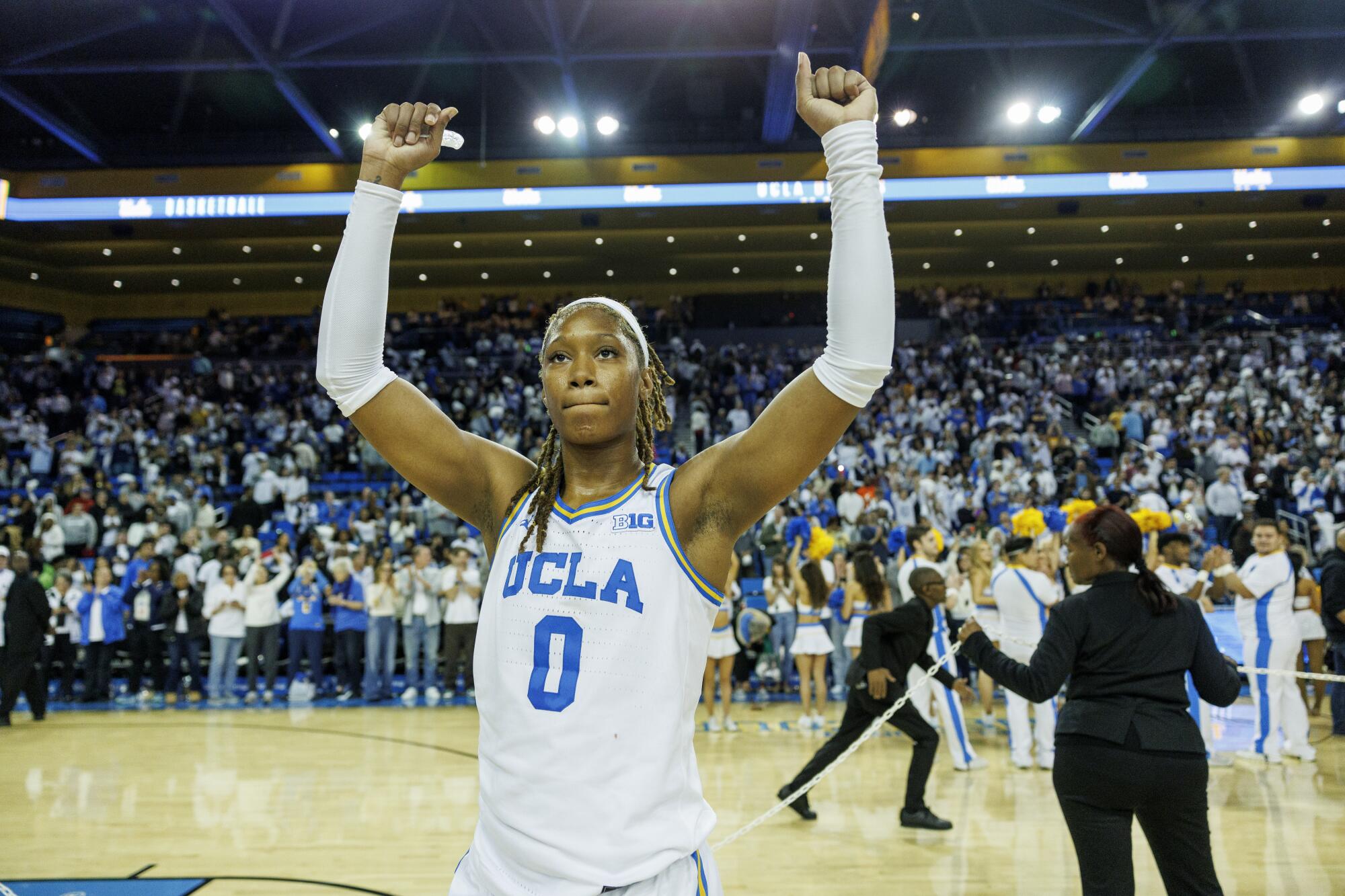 UCLA forward Janiah Barker raises her arms in the air and celebrates after the Bruins beat No. 1 South Carolina 