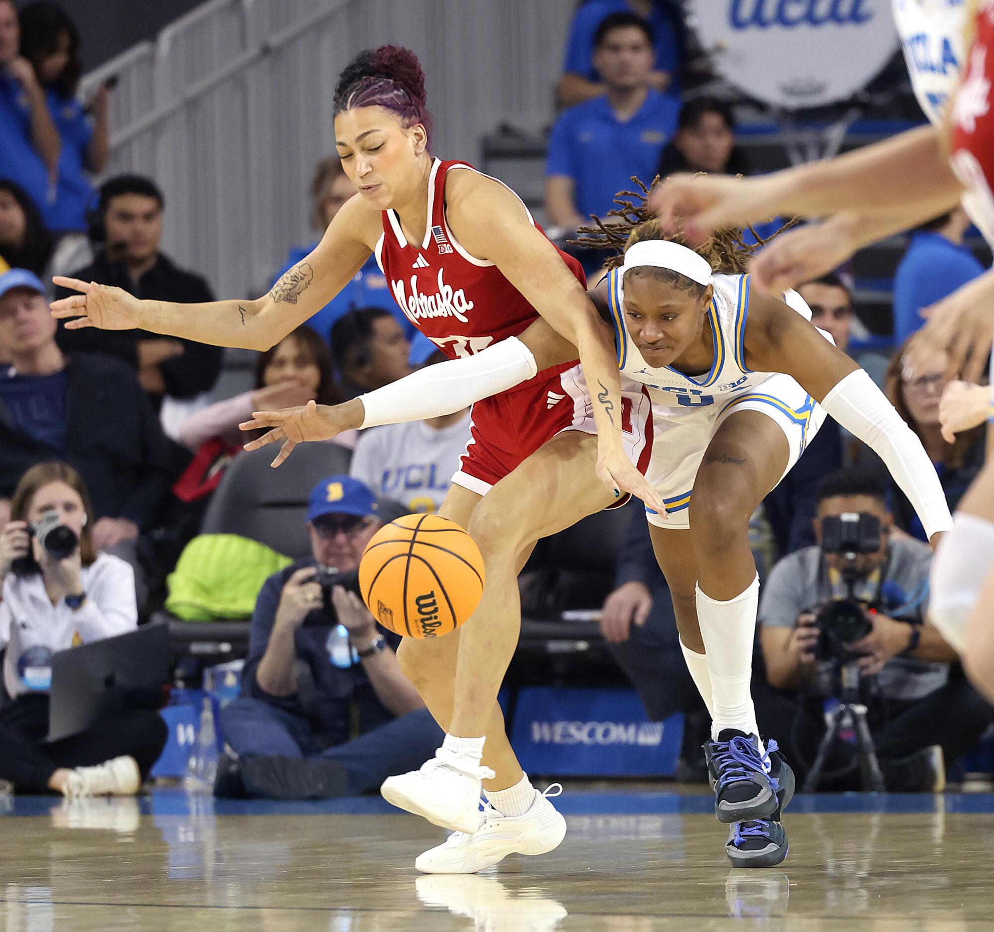 UCLA's Janiah Barker fights for the ball against Nebraska's Kendall Coley at Pauley Pavilion on Sunday.