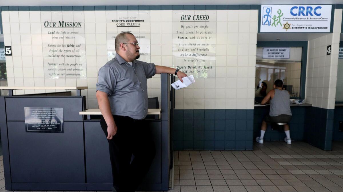 Ismael Vedoy, bail agent at Bad Boys Bail Bonds, waits to post a bond for a client at the Los Angeles County Jail.