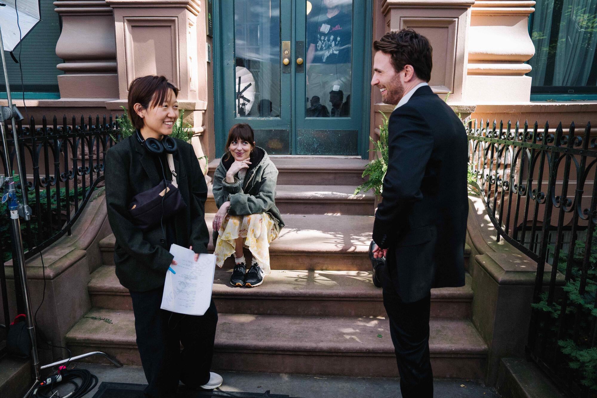 A director gives notes to actors on an apartment stoop.