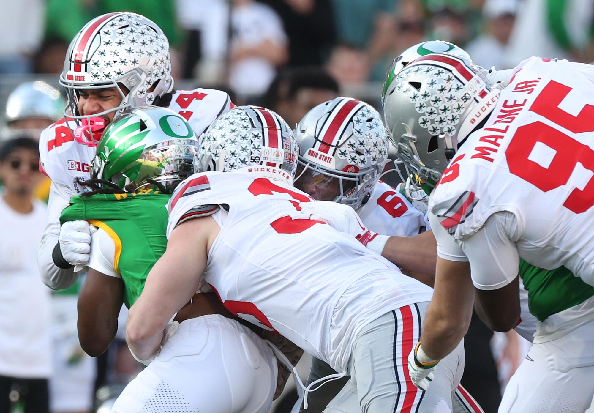 Oregon running back Noah Whittington is stopped by the Ohio State defense during the Rose Bowl on Wednesday.