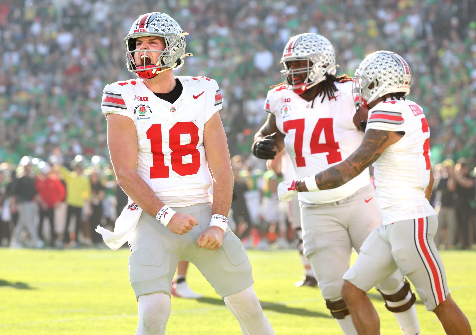 Ohio State quarterback Will Howard celebrates after throwing a touchdown pass against Oregon at the Rose Bowl.