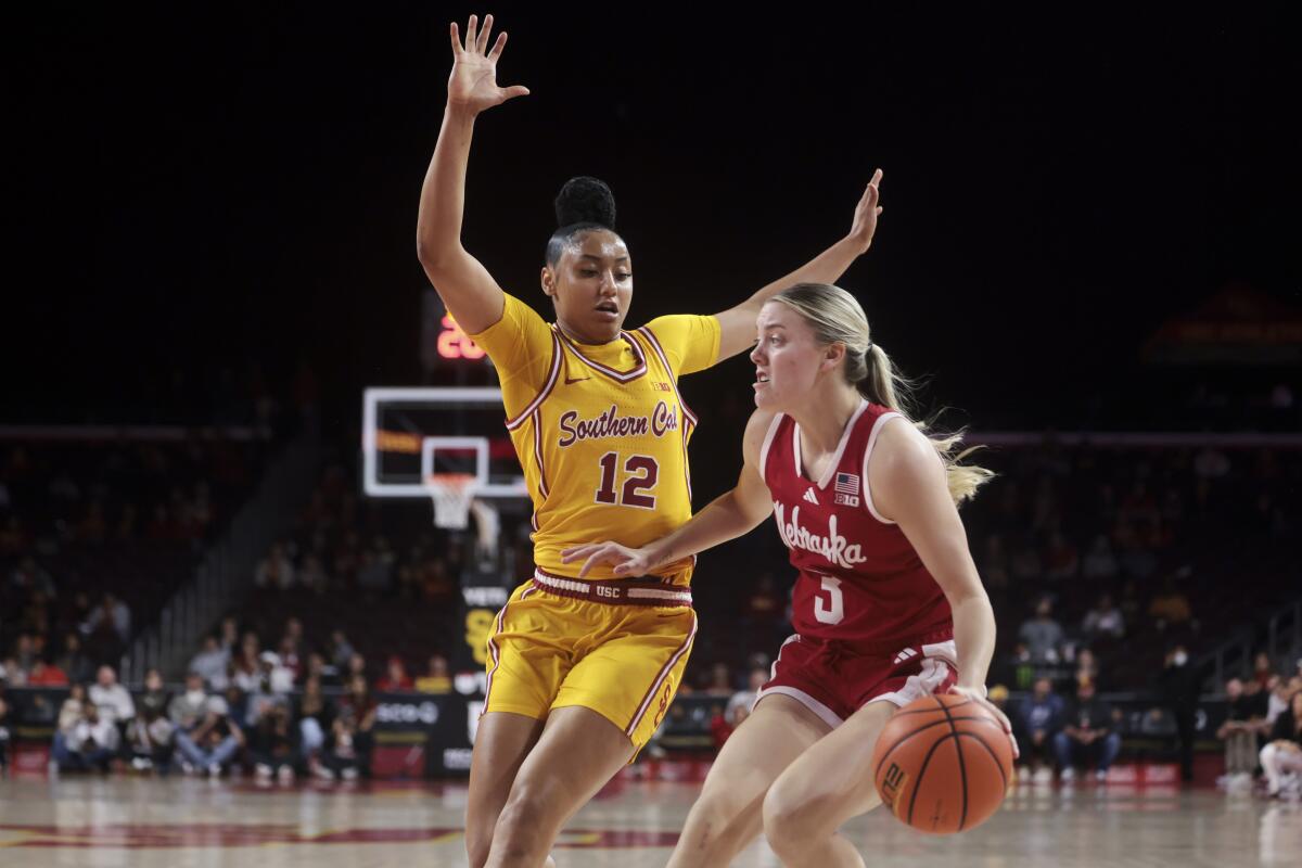 Southern California guard JuJu Watkins (12) defends against Nebraska guard Allison Weidner.