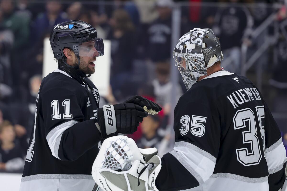 Los Angeles Kings center Anze Kopitar, left, celebrates with goaltender Darcy Kuemper.