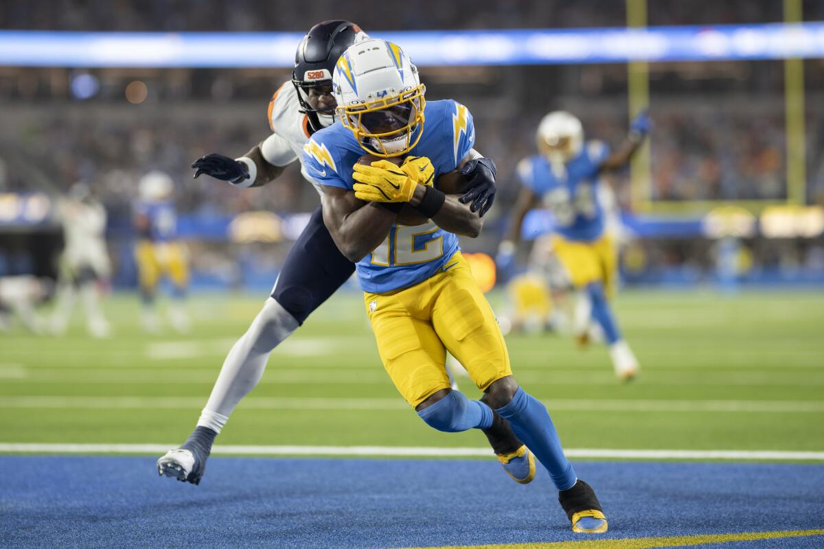 Los Angeles Chargers wide receiver Derius Davis (12) scores a touchdown past Denver Broncos.