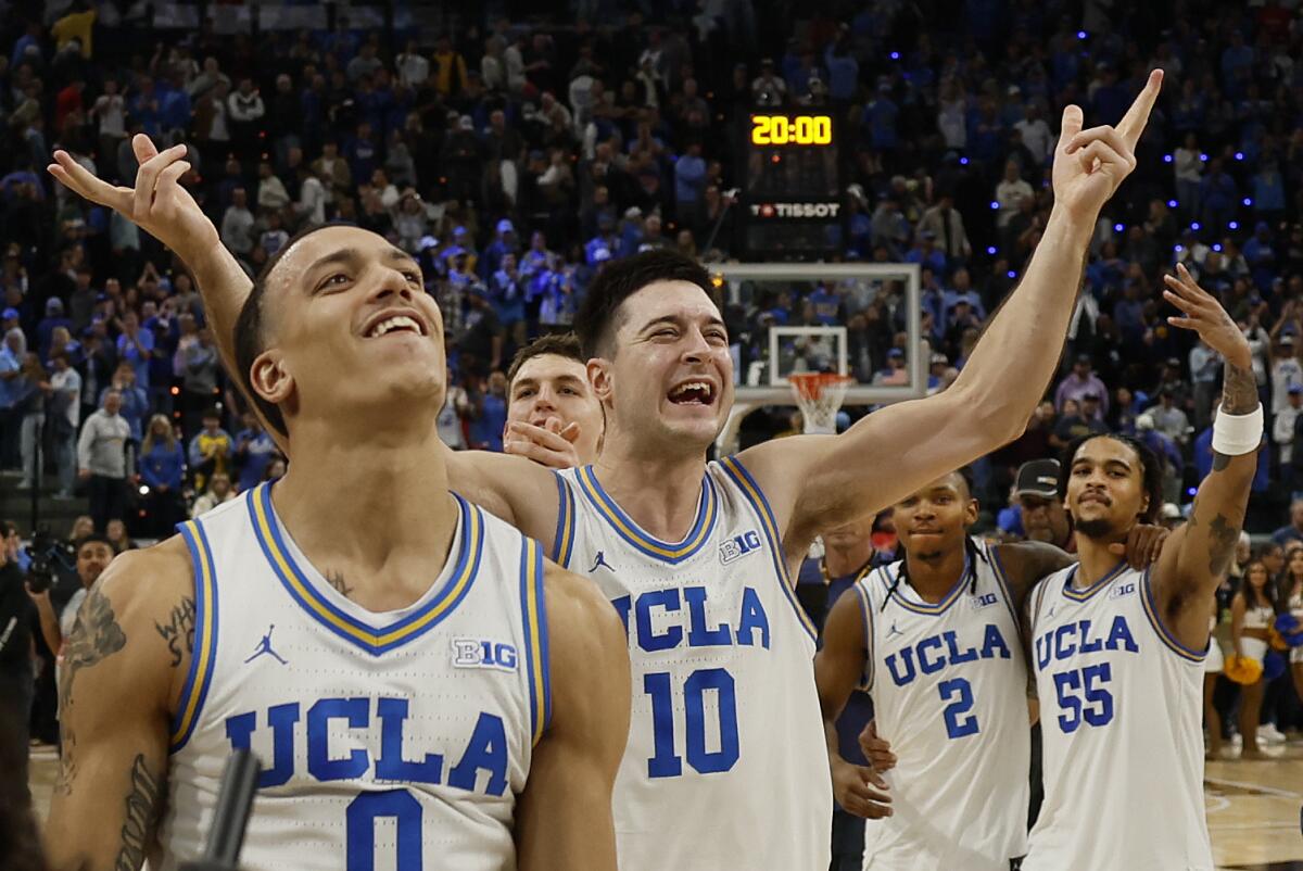 UCLA's Kobe Johnson, Lazar Stefanovic, Dylan Andrews and Skyy Clark raise their arms and celebrate beating Gonzaga