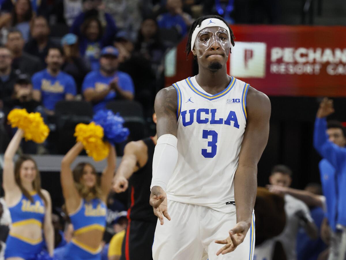 UCLA's Eric Dailey Jr. wears a face mask and celebrates making a three-pointer against Gonzaga at the Intuit Dome