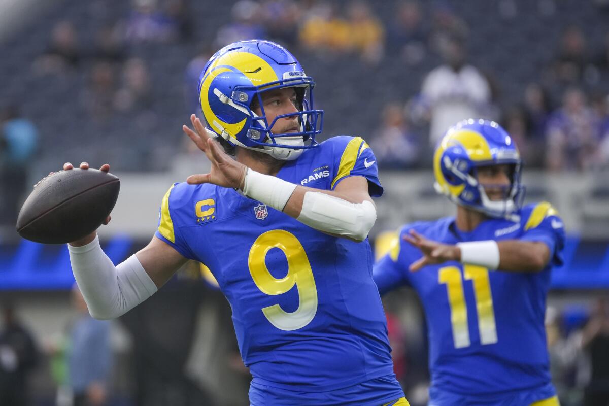 Los Angeles Rams quarterbacks Matthew Stafford (9) and Jimmy Garoppolo (11) work out.