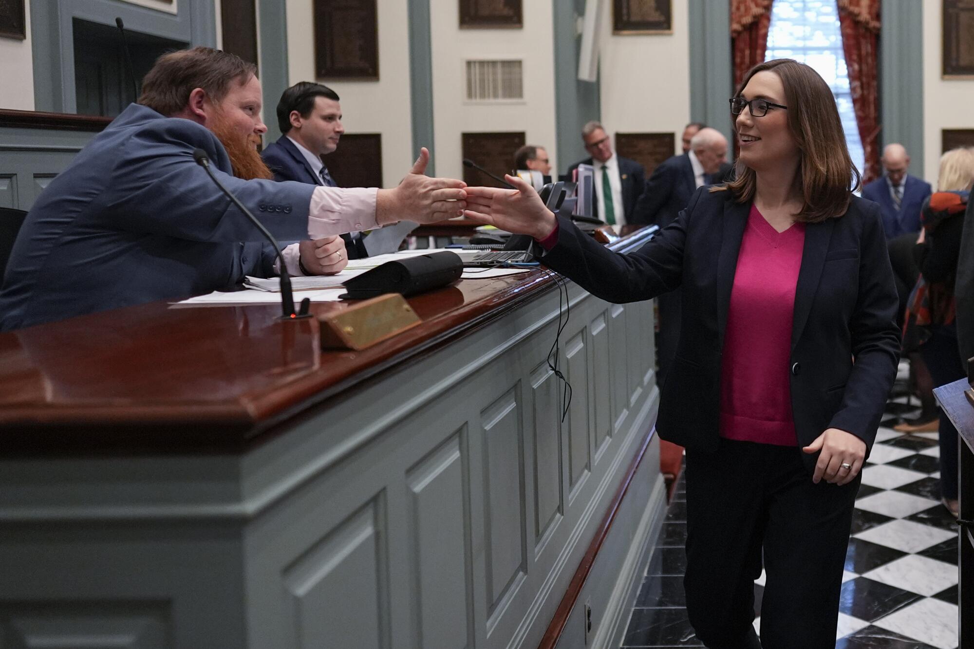 Sarah McBride high-fives a colleague.